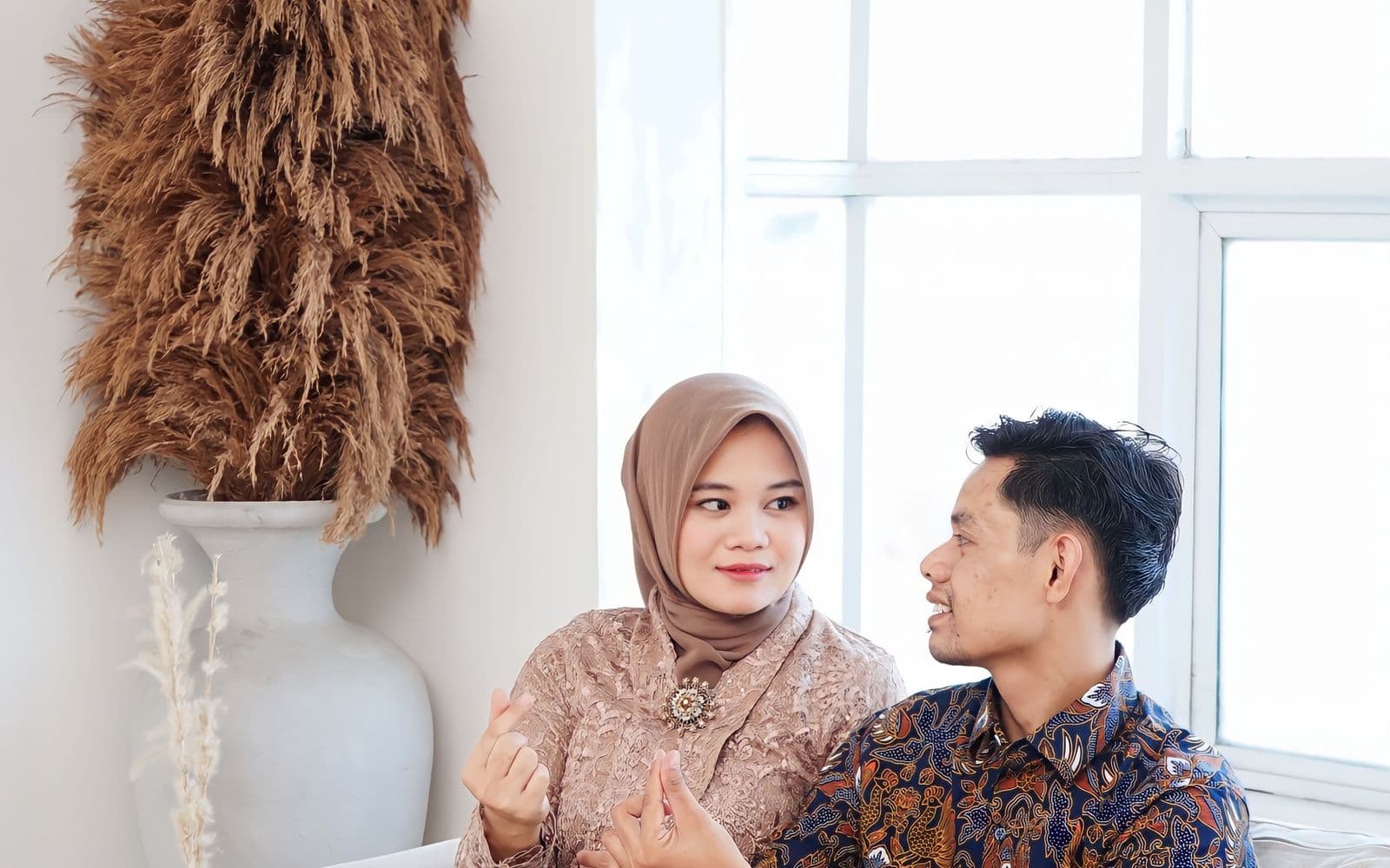 A happy Malaysian couple planning their future together at home